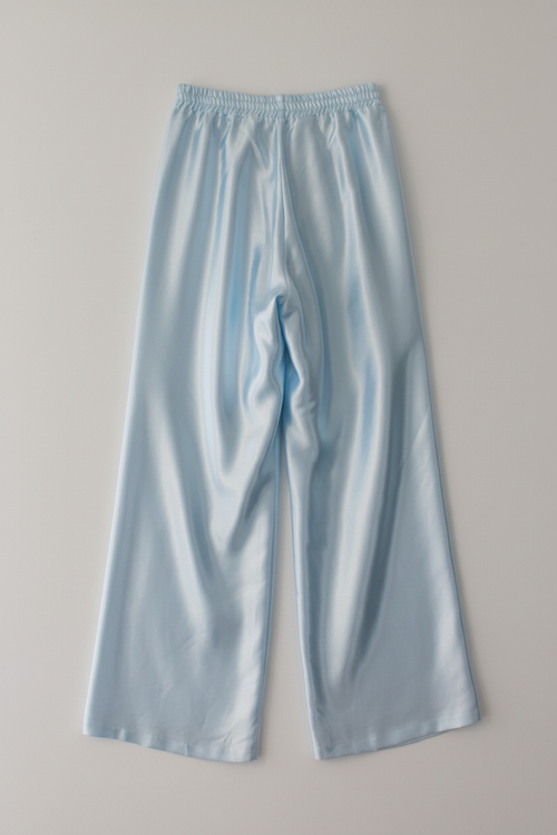 Lay flat back view of pale blue satin wide-leg trousers