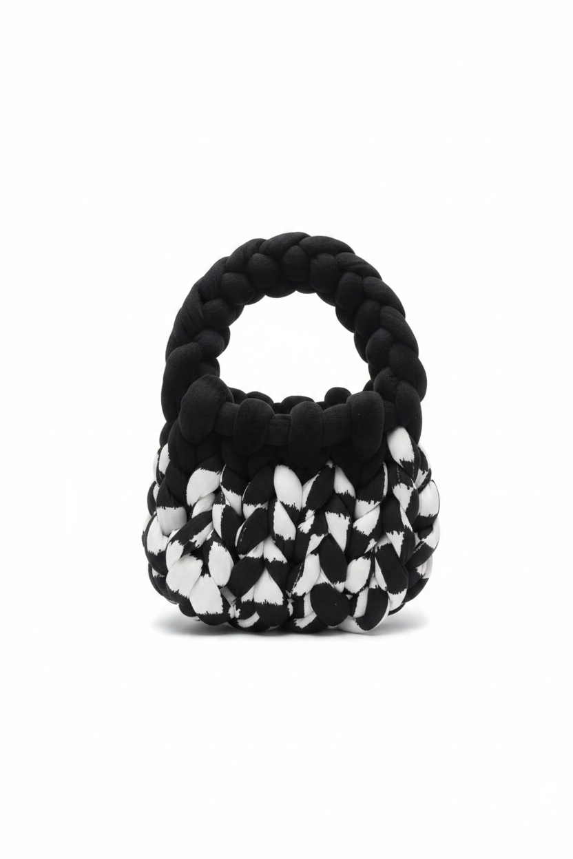 Black and white chunky braided knit bag handle view on white background