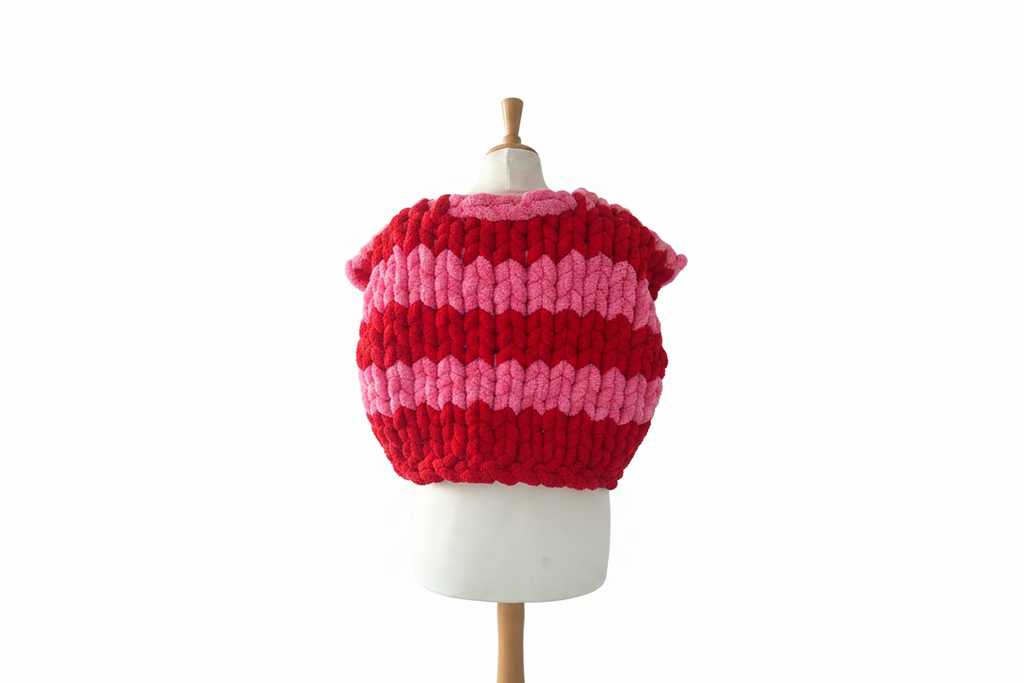 Pink and red striped chunky knit cardigan vest back view on mannequin with white background
