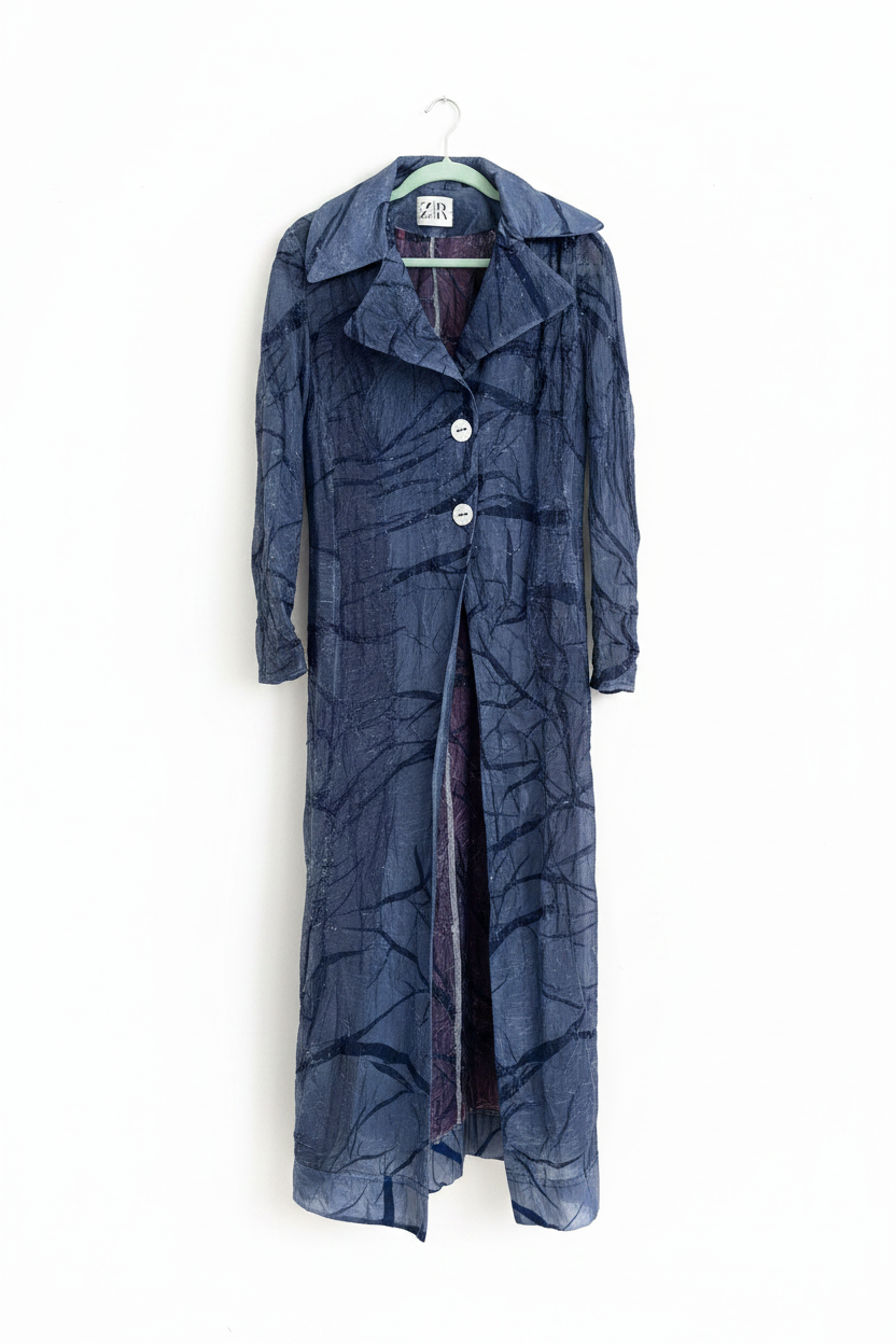 Navy crinkle iridescent maxi coat on hanger on white background