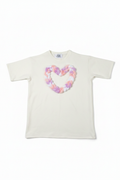 White oversized tee with pastel braided heart appliqué flat lay on white background