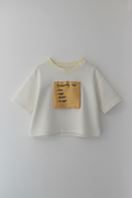 Lay flat image of white oversized crop t-shirt with shopping list graphic print