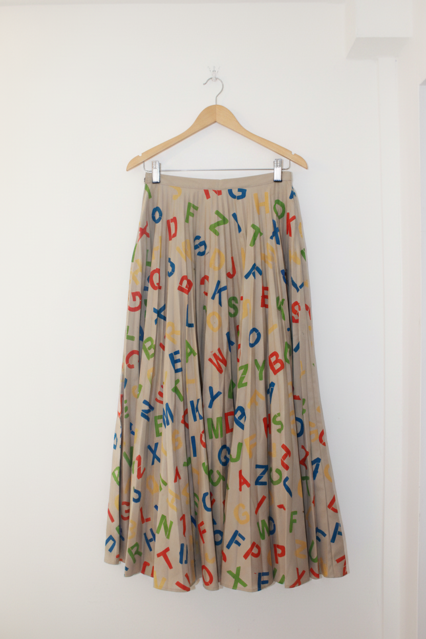 Alphabet Skirt Brown on hanger against white background